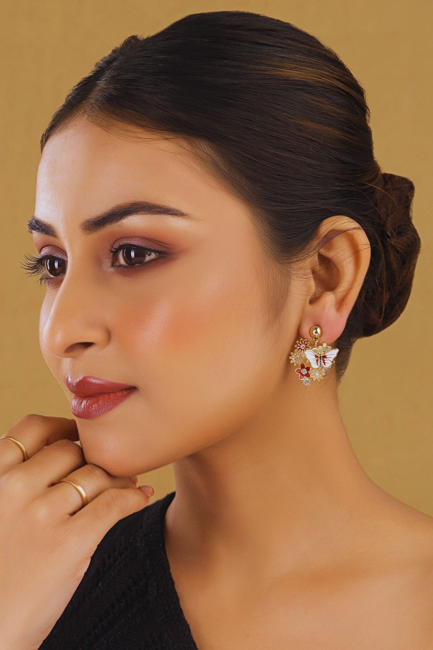 Woman wearing earrings with a neutral background