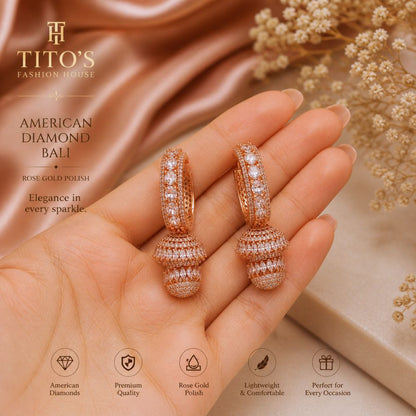 Rose gold hoop earrings held in a hand with Tito's Fashion House branding.
