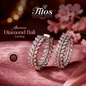 Rose gold diamond earrings on a pink fabric with 'Titos Fashion House' branding.