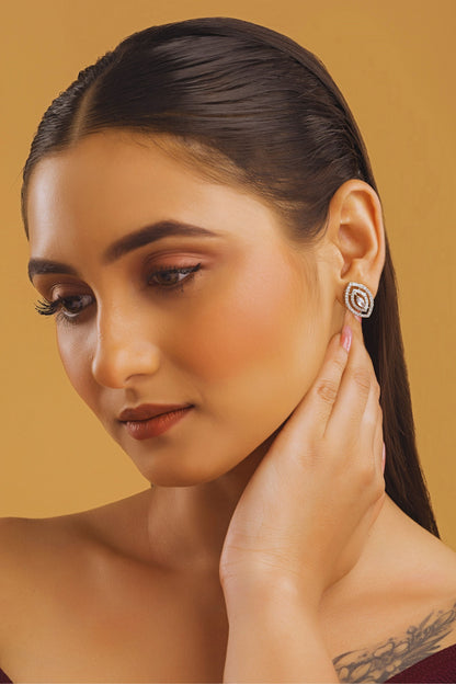 Woman wearing earrings on a beige background