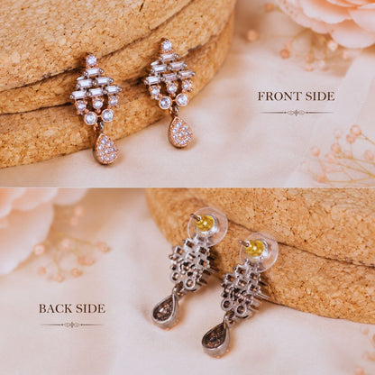 Pair of earrings shown from front and back sides on a textured surface.