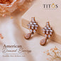 Pair of American Diamond Earrings with 'TITOS Fashion House' branding on a soft fabric background.