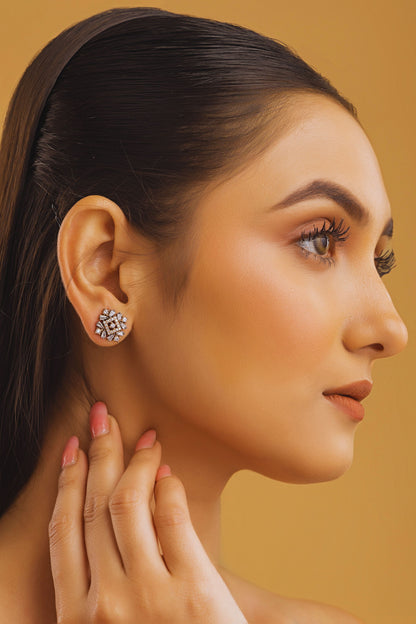 Woman wearing a diamond earring on a beige background
