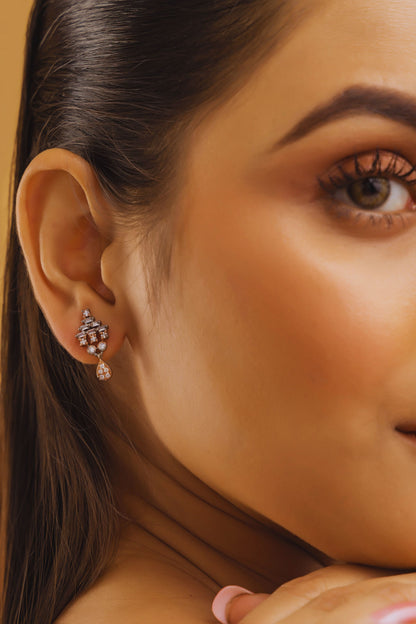 Close-up of a woman's ear with a diamond earring on a beige background