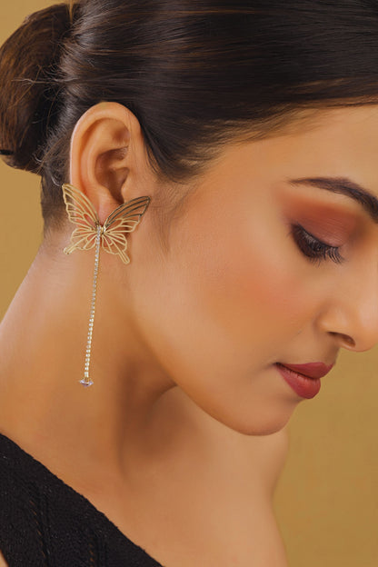 Close-up of a woman wearing a butterfly-shaped earring with a blurred background