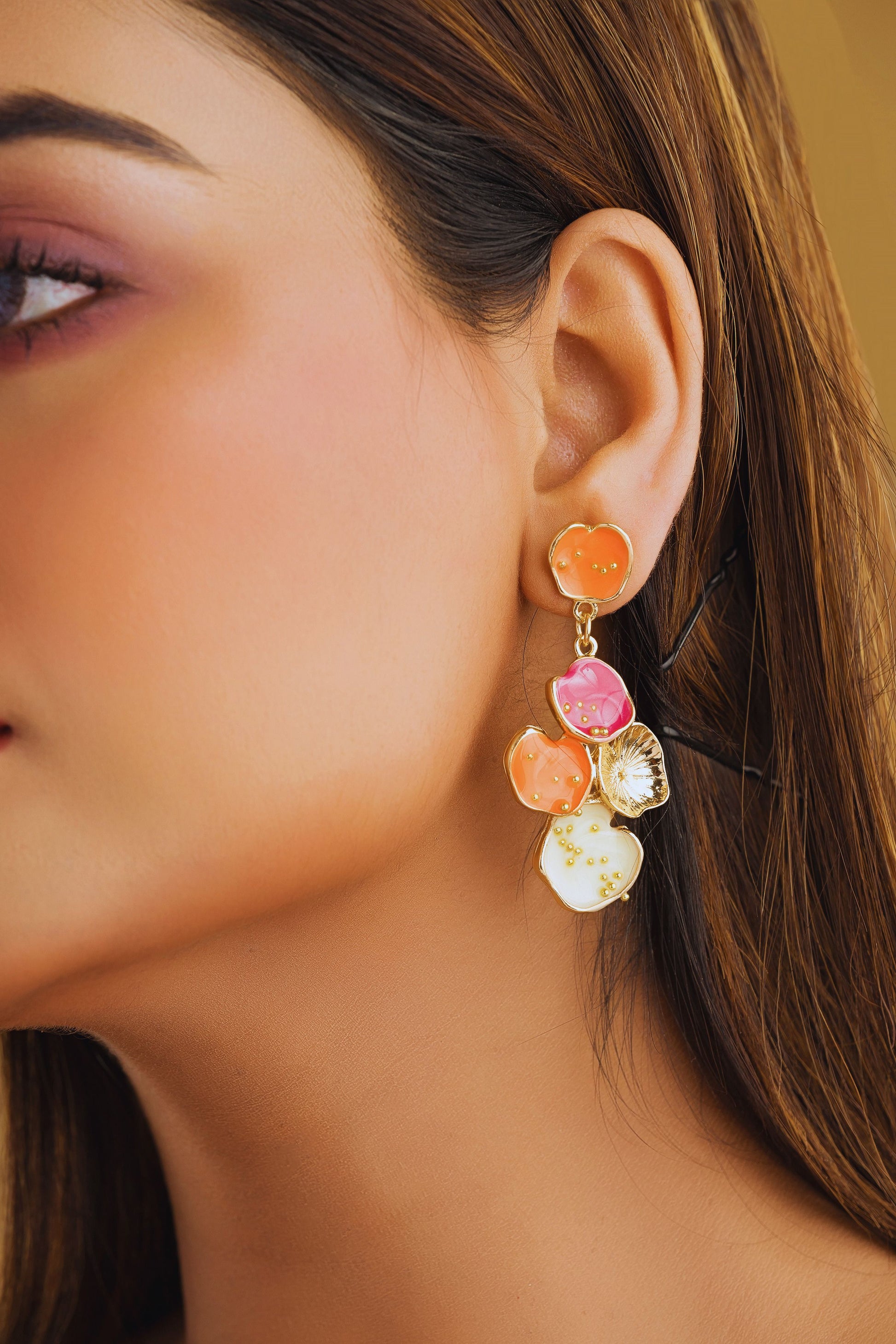 Close-up of a woman wearing colorful earrings with a blurred background
