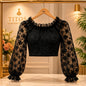 Black lace top on a hanger with 'TITOS Fashion' logo in the background