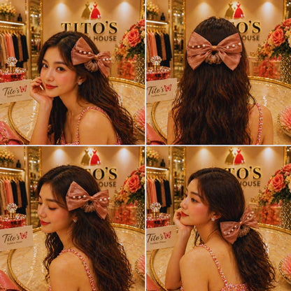 Woman wearing a large pink hair bow in a store setting with 'Tito's' branding.