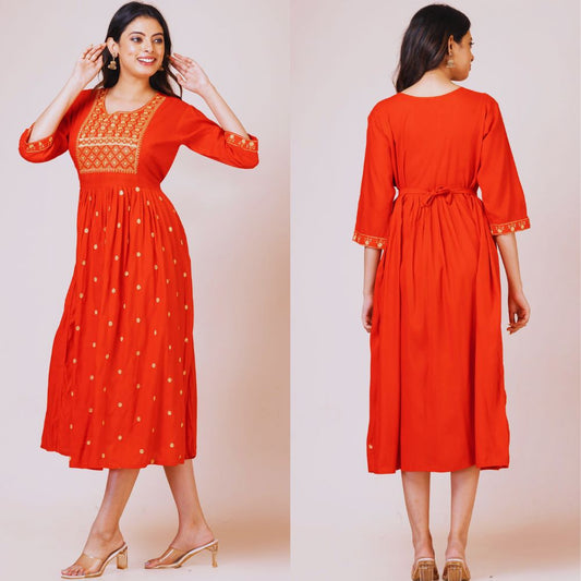 Red dress with gold embroidery on a plain background