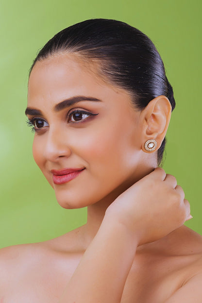 Woman wearing earrings against a green background