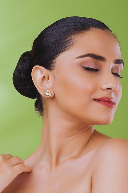 Woman wearing earrings against a green background