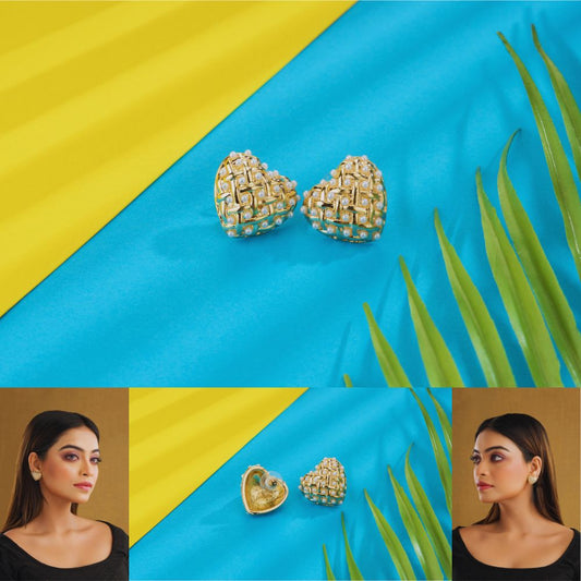 Pair of gold earrings on a blue and yellow background with a woman wearing them.