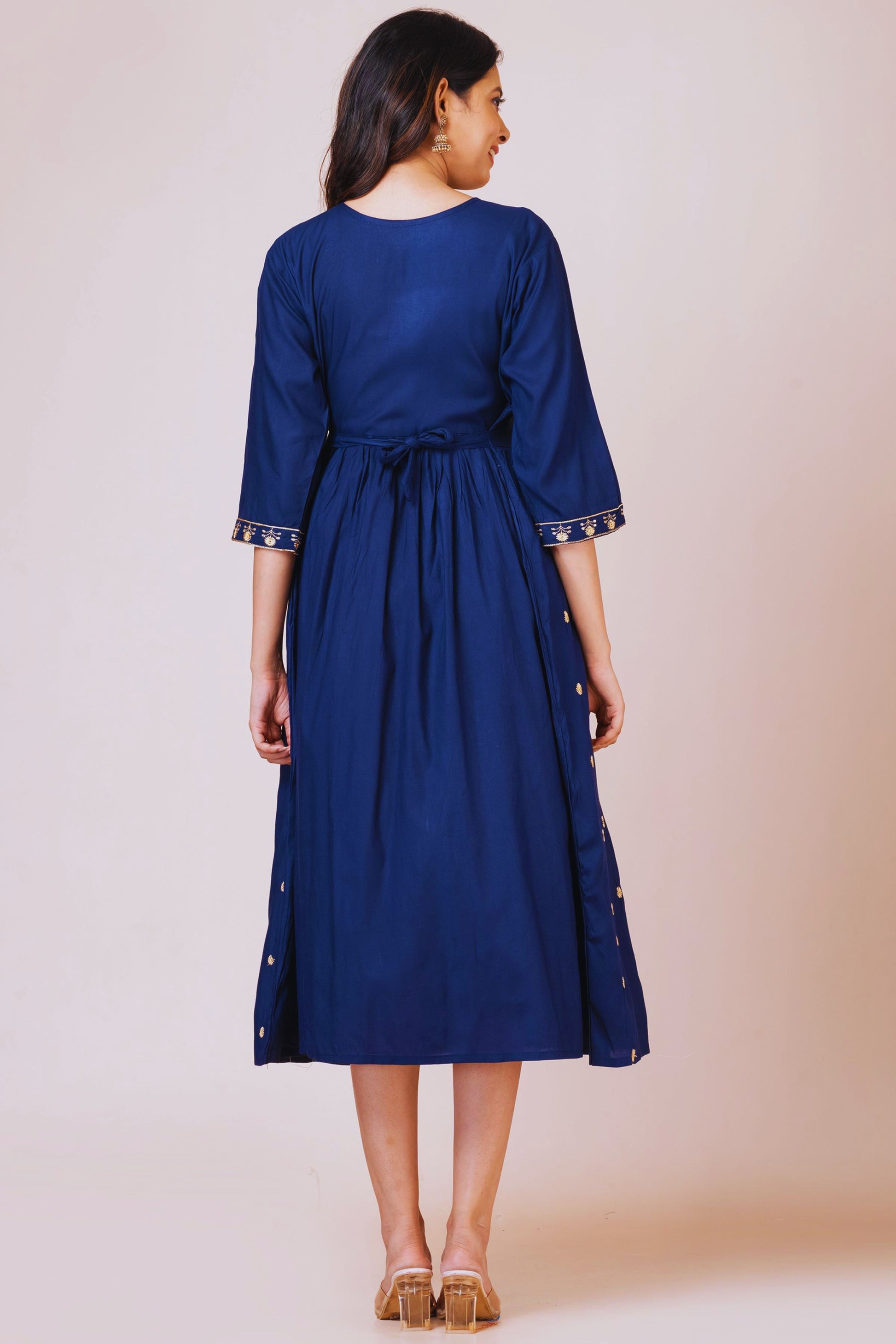 Woman wearing a blue dress with a plain background