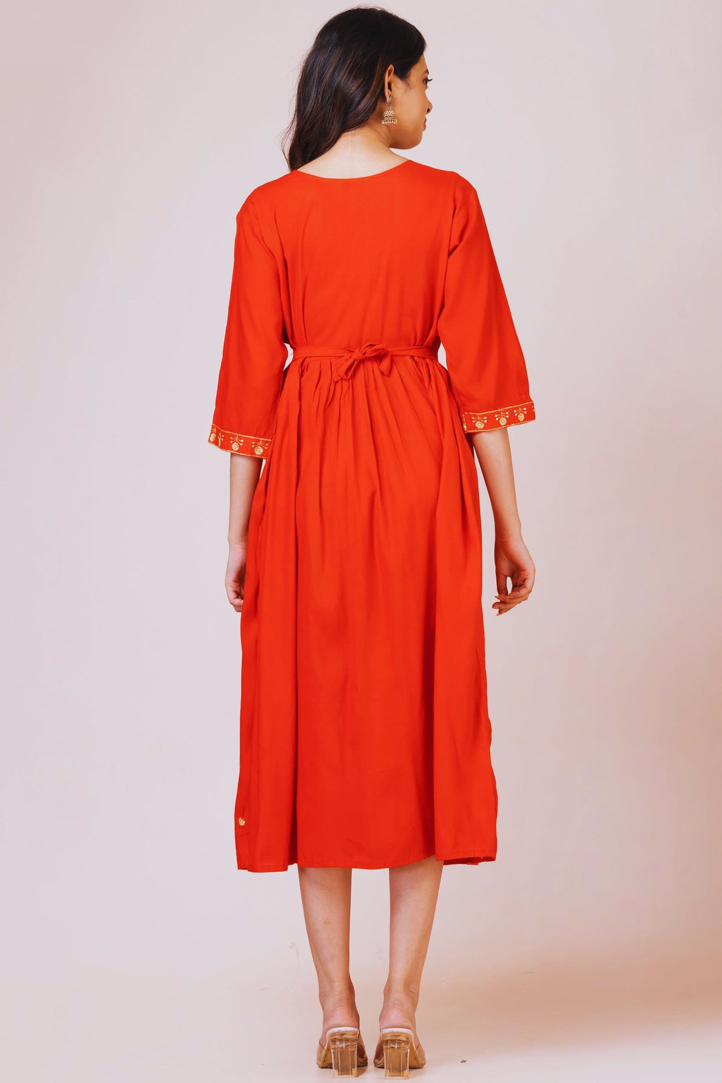 Woman wearing a red dress with a plain background