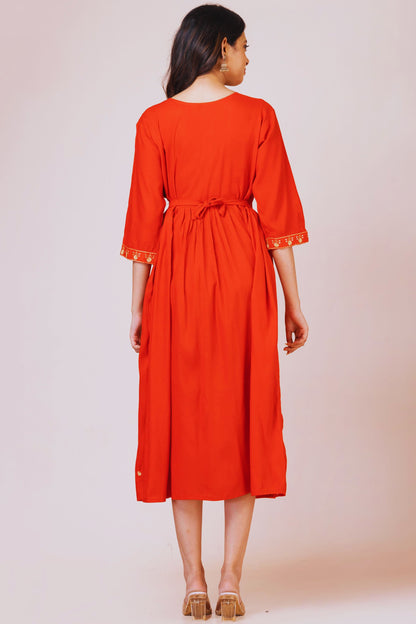 Woman wearing a red dress with a plain background