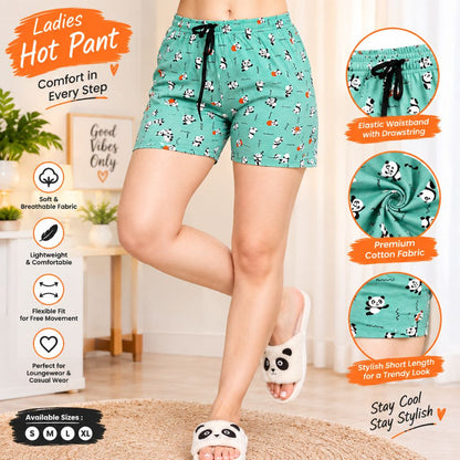 A Ladies Short Pant, woman modeling mint green patterned hot pants with a black drawstring, shown in a styled indoor setting with promotional text and fabric detail callouts. The shorts have a repeating panda print on a light green background.