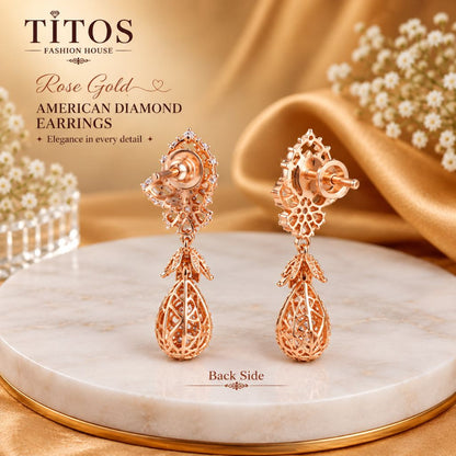 A pair of rose gold American diamond drop earrings displayed on a round white marble pedestal with a gold rim, set against a warm gold satin fabric backdrop with small white flowers. The brand name 'TITOS FASHION HOUSE' is visible in the top left corner, along with the text 'Rose Gold AMERICAN DIAMOND EARRINGS' and 'Back Side' at the bottom.