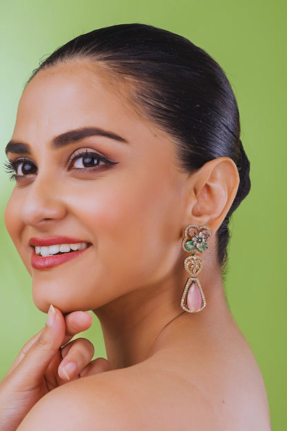 Woman wearing earrings with a green background