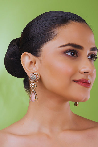 Woman wearing earrings with a green background