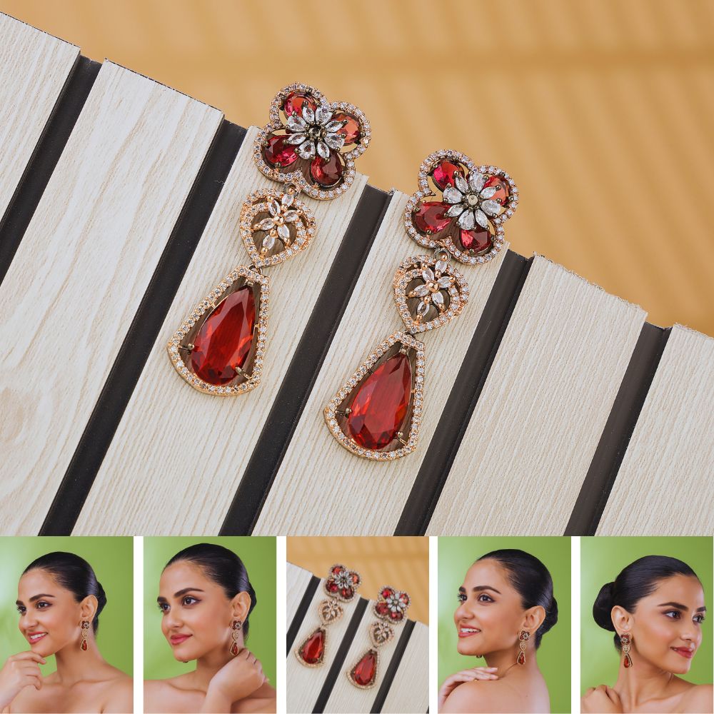 Pair of ornate earrings with red gemstones on a striped surface, with models wearing the earrings.