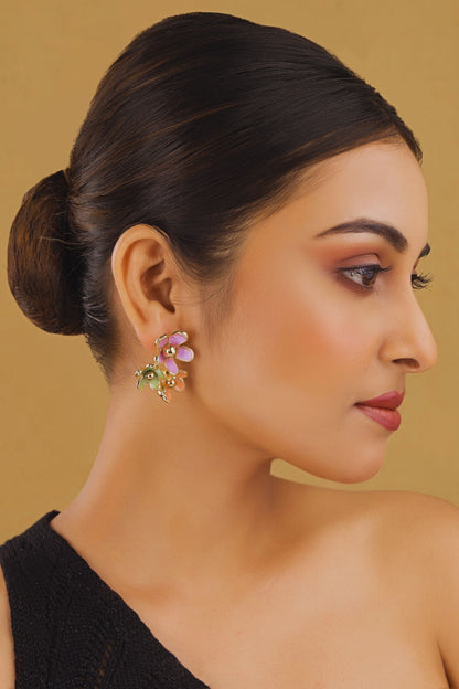 Woman wearing colorful earrings with a neutral background