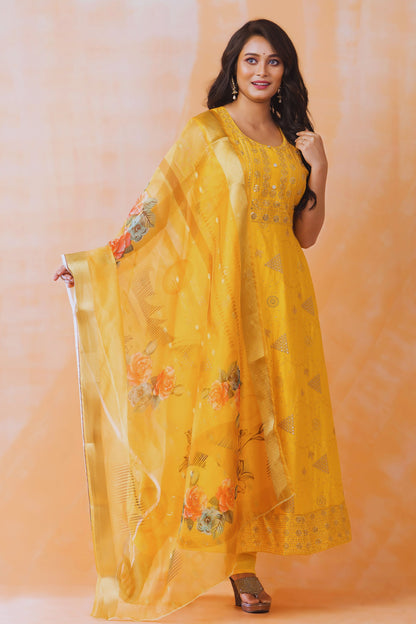 Woman wearing a yellow floral dress against an orange background
