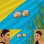 Colorful floral earrings on a blue and yellow striped background with a woman wearing them.