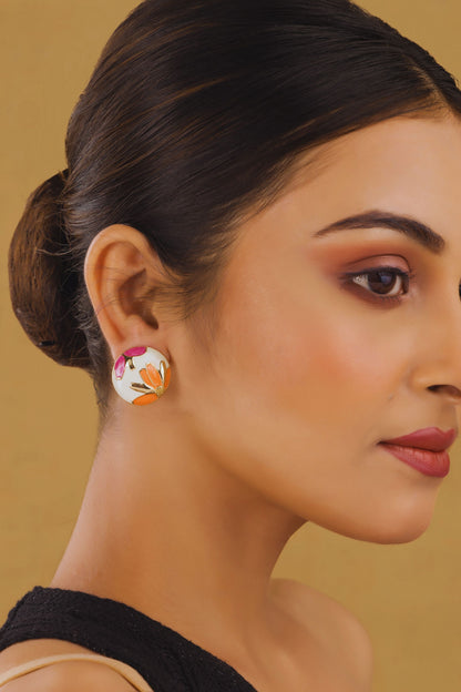 Woman wearing a floral earring against a beige background