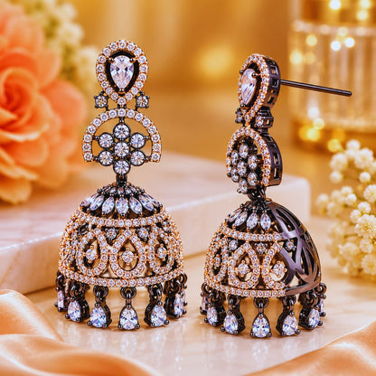 Ornate earrings with intricate designs on a soft fabric background