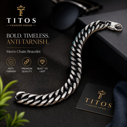 Silver chain bracelet on a dark surface with TITOS branding.