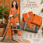 A woman models an orange cotton unstitched salwar suit set with a matching dupatta, alongside folded views of the suit components. The set features intricate floral embroidery, geometric borders, and green panels.