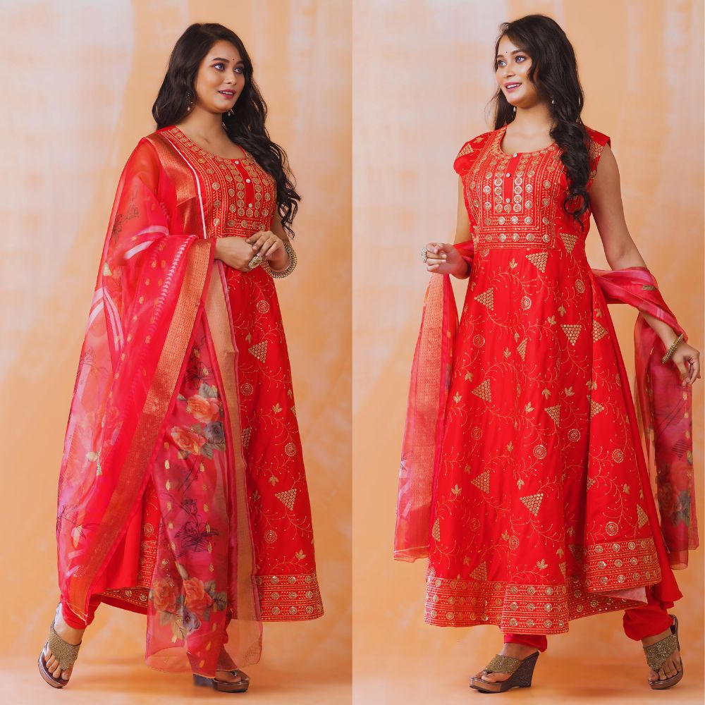 Woman wearing a red traditional outfit with gold patterns on an orange background