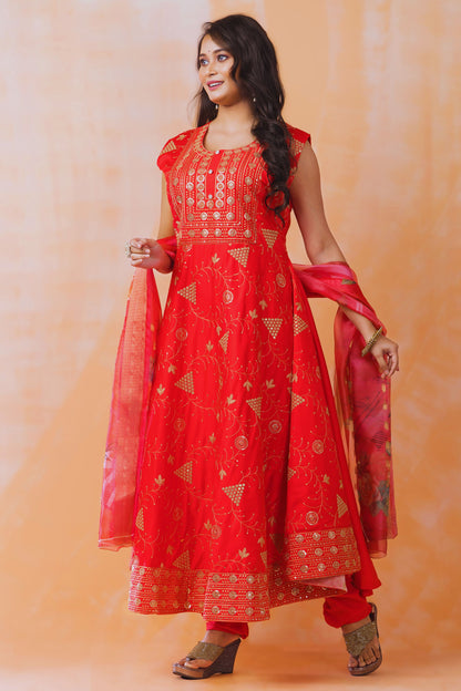 Woman wearing a red embroidered traditional outfit on an orange background