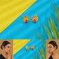 Gold earrings with red berries and green leaves on a blue and yellow background with grass.