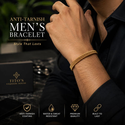 A man wearing a gold chain-link men's bracelet, with promotional text and a black branded box for Tito's Fashion House in the background.