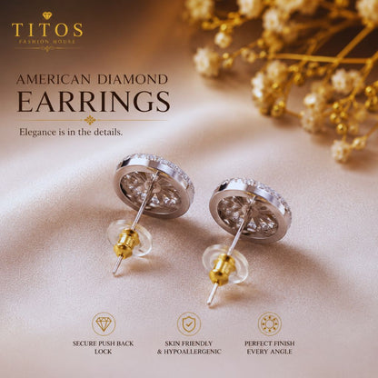 Silver earrings with gold accents on a beige surface, featuring TITOS Fashion House branding.