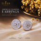 Diamond earrings on a beige fabric background with 'TITOS Fashion House' branding.