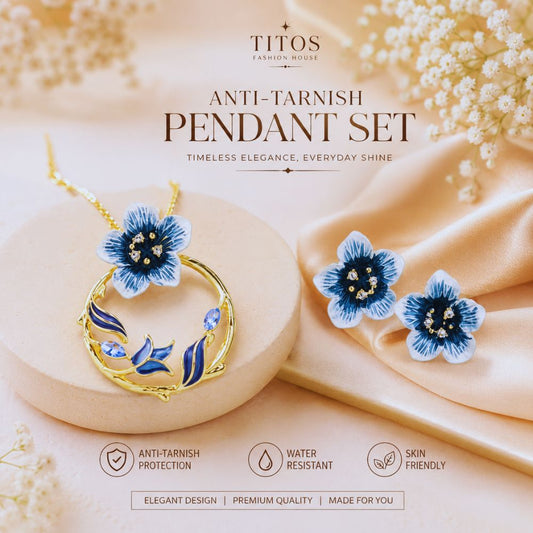 Jewelry set with blue floral pendant and earrings on a soft beige background, featuring the brand 'TITOS'.