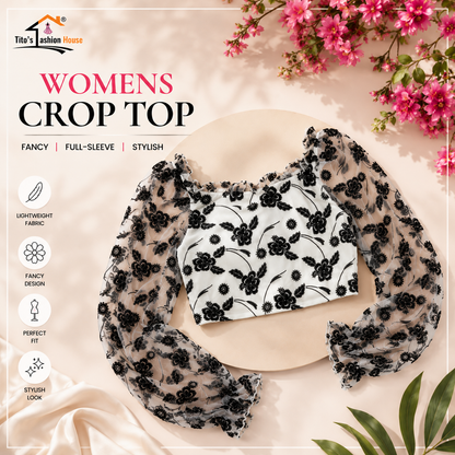 Black floral lace crop top on a beige background with pink flowers and green leaves.