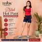 A woman modeling a pair of dark navy blue hot pants with decorative gold buttons, styled with a red sleeveless top and blue slide sandals. The image is a promotional graphic for 'TITO'S Fashion House' styled Hot Pant, featuring product details on the left and a potted plant on the right against a peach-colored background.